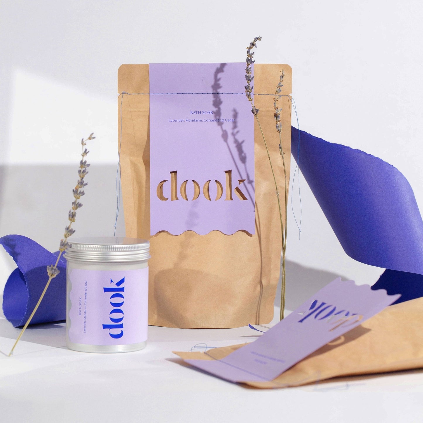lavender bath salts in a tub and brown pouch