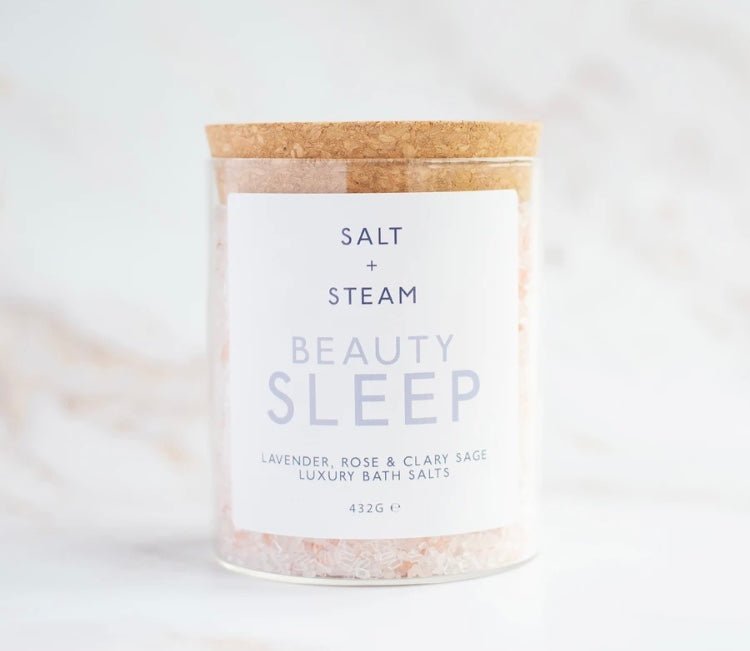 glass jar with a cork lid, holding pink and white bath salts