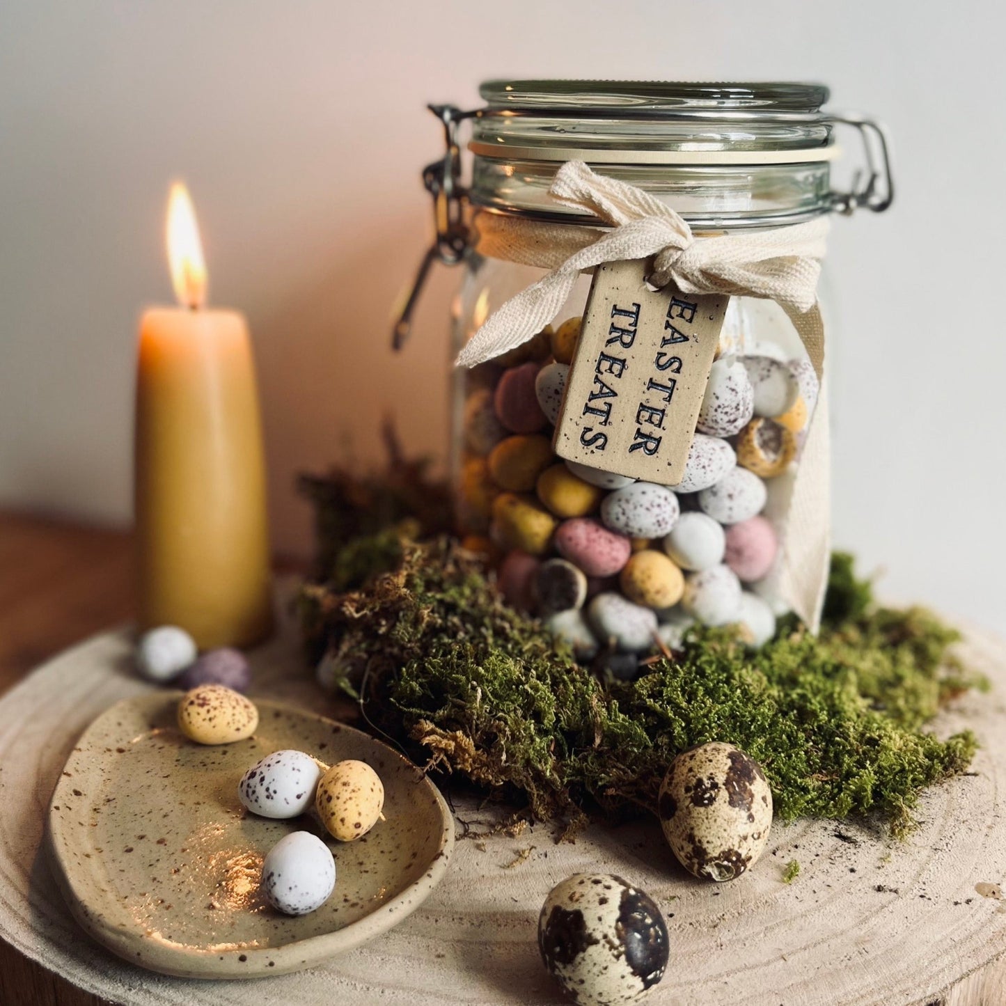 ceramic tag tied around a glass jar filled with mini eggs