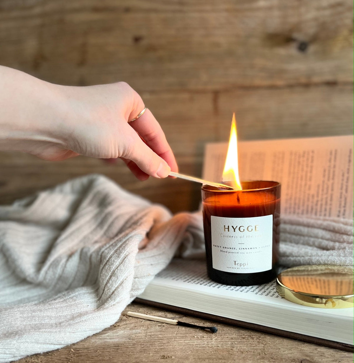 hand lighting hygge candle