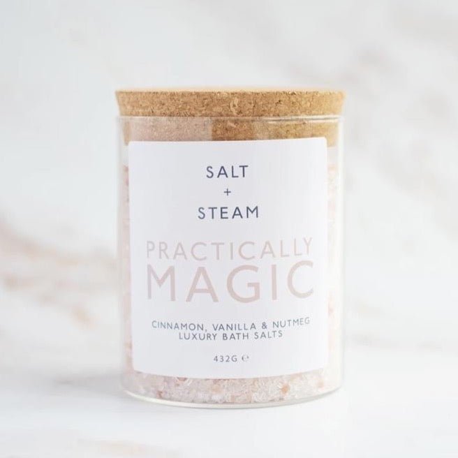 a corked glass jar holding pink and white salt crystals