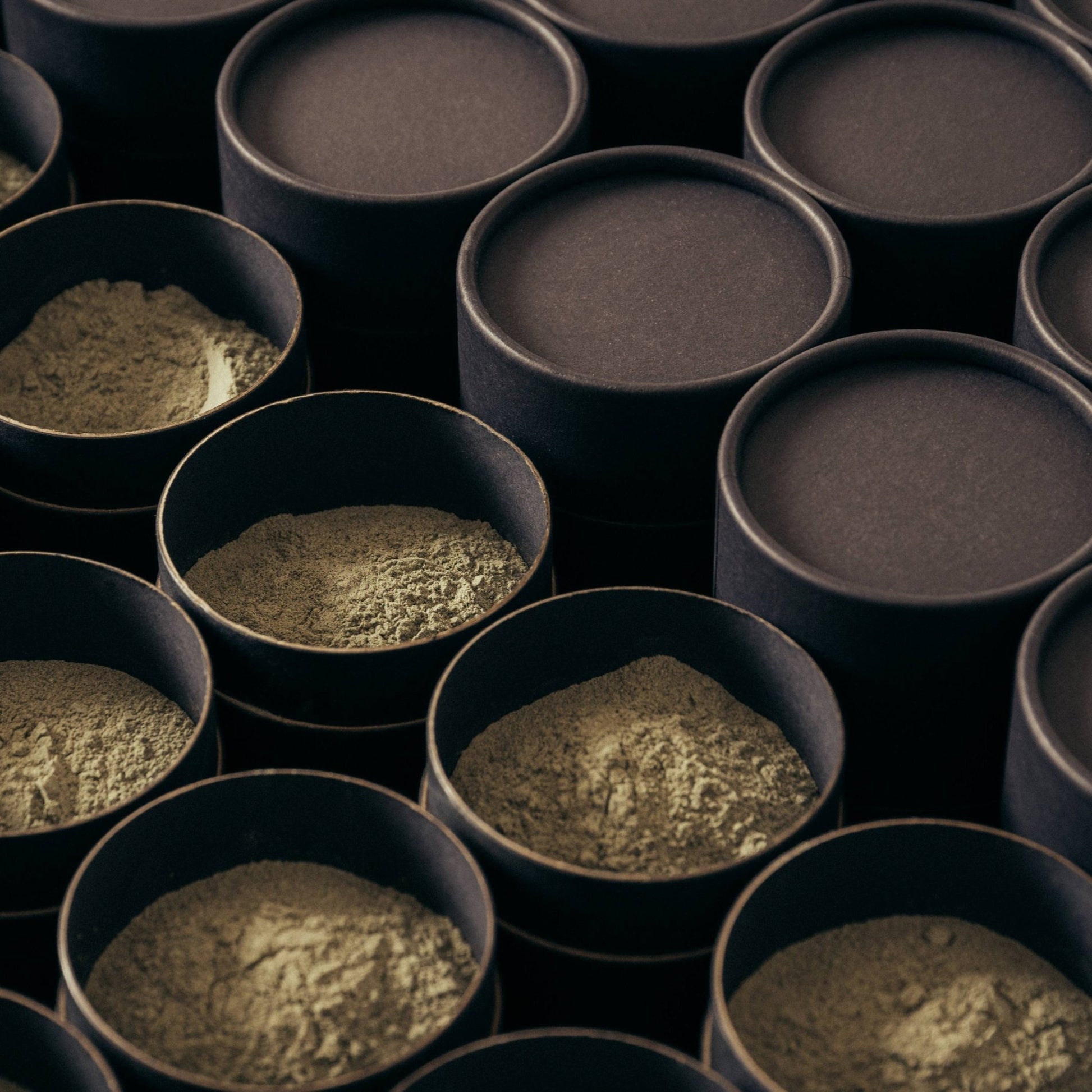 brown cylinder tubs filled with green clay