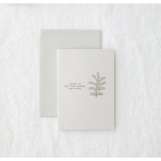 grey greetings card with a plant illustration, laid on a grey envelope