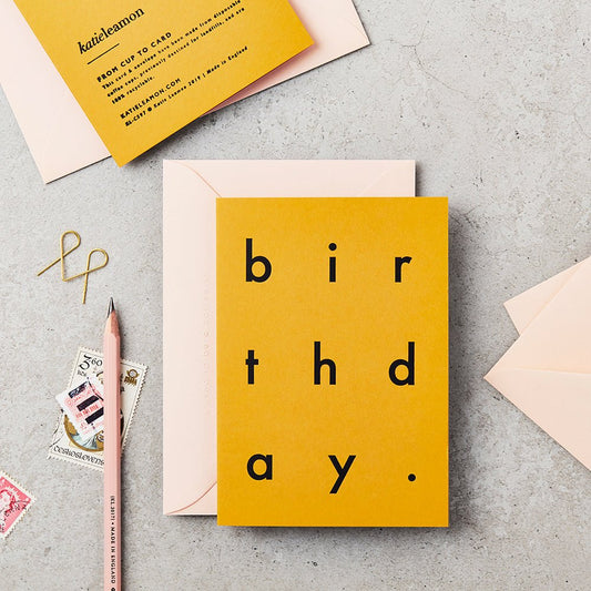 Mustard coloured greetings card with spaced out black lettering
